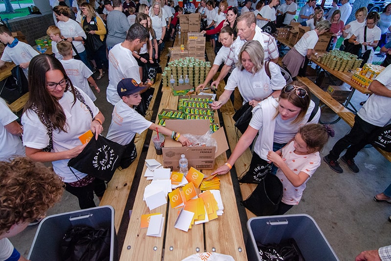 Volunteers taking a self during backpack building.