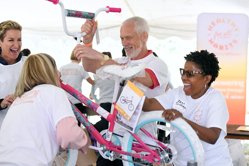 Volunteers preparing bicycles for donation to school children.