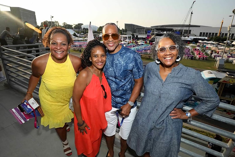 Group of four attendees outside, smiling for the camera at the Optavia block party at the Home Depot Backyard.